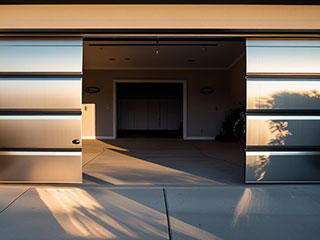 Modern Automatic Garage Door with Advanced Technology in Grayslake, IL Sleek, high-tech automatic garage door opening at sunset, showcasing new technology upgrades for modern homes in Grayslake, IL.