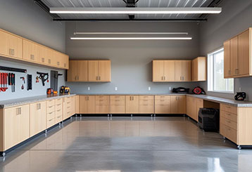 Spacious garage featuring custom cabinets, wall-mounted tools, and organized workspaces in Grayslake, IL home.