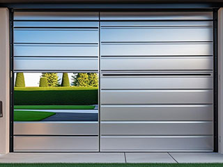 Contemporary electric garage door with a sleek automated design, partially open in a modern Grayslake, IL home.