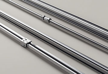Close-up of high-quality, shiny garage door tracks and cables used in professional repairs and installation.