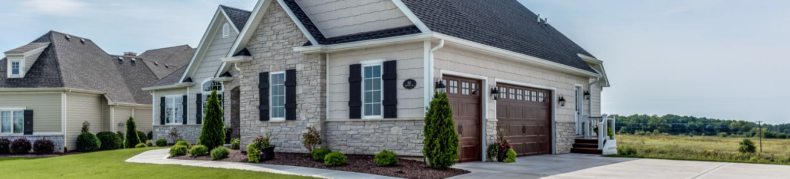 Beautiful suburban home with modern double garage doors and a landscaped driveway in Grayslake, IL.