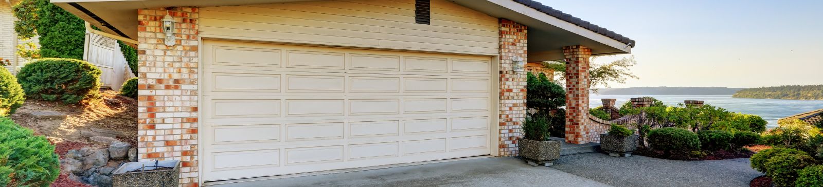 White residential garage door with scenic lake view in Grayslake, IL, representing professional maintenance and repair services.