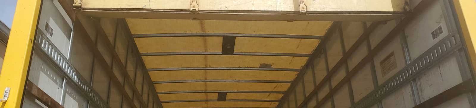 Technician securing components during sectional overhead garage door install in Lindenhurst IL